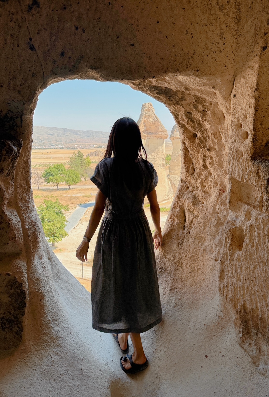 Panoramic view of Cappadocia fairy chimneys at golden hour.